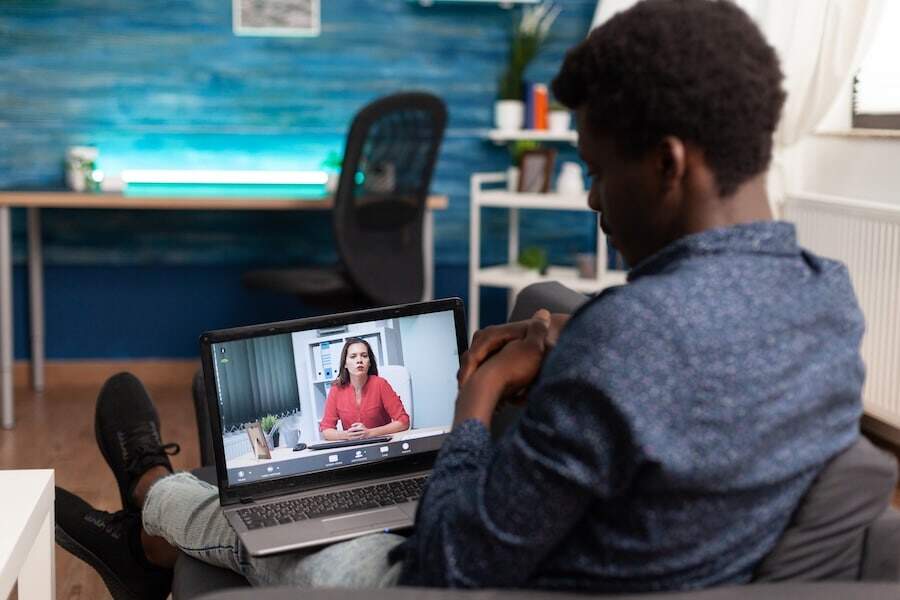 A man on laptop watching a video learning course