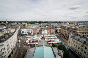 Aerial filming of the city of Cambridge with colorful stalls market