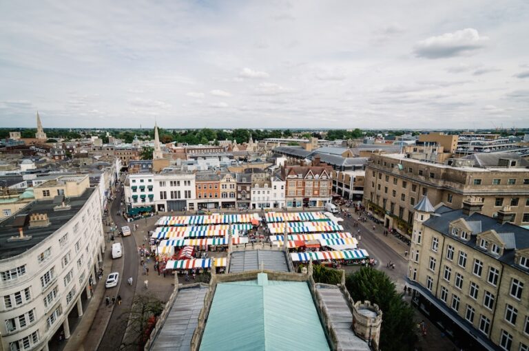 Aerial filming of the city of Cambridge with colorful stalls market
