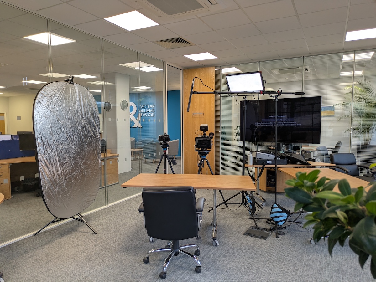 Lights, camera, boom mic negative fill filmin gset up in Norwich office